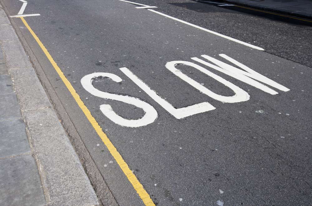 "SLOW" Road markings