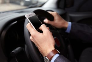 driving with mobile phone in hand
